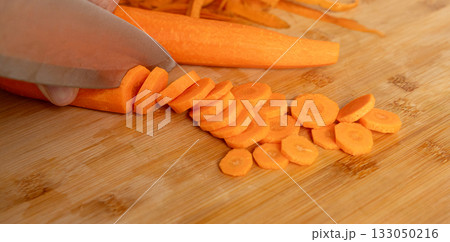 Cutting Fresh Carrot with Knife Close Up, Raw Carrot Slices Closeup, Orange Root Vegetable 133050216