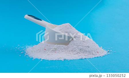 Detergent powder pile. Laundry washing soap granules, small white texture of oxygen bleach Detergent powder pile. Laundry washing soap granules, small white texture of oxygen bleach 133050252