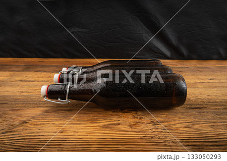 Old beer bottle, brown glass vintage beerbottle, a quality traditional time-tested drink symbol Old beer bottle, brown glass vintage beerbottle, a quality traditional time-tested drink symbol 133050293