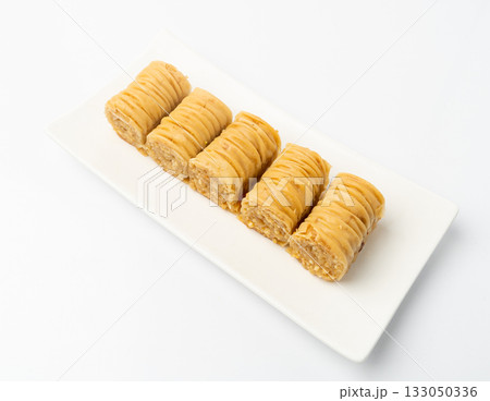 Rolled Baklava Isolated, Ramadan Dessert Roll on Restaurant Plate, Eastern Sweet Pastries 133050336