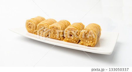 Rolled Baklava Isolated, Ramadan Dessert Roll on Restaurant Plate, Eastern Sweet Pastries 133050337