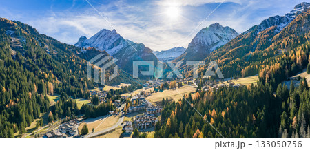Panorama of the Dolomites mountains with Canazei town during autumn. Beautiful mountians of Alpi Dolomiti in Italy, South Tirol 133050756