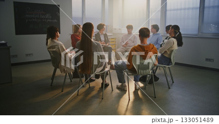 Teen Students Sit in Circle With Caring Teacher Discussing Psychology and Self Awareness Teen Students Sit in Circle With Caring Teacher Discussing Psychology and Self Awareness 133051489