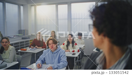 Adult Woman Wearing Glasses Actively Writes With Marker on Invisible Interactive Board 133051542