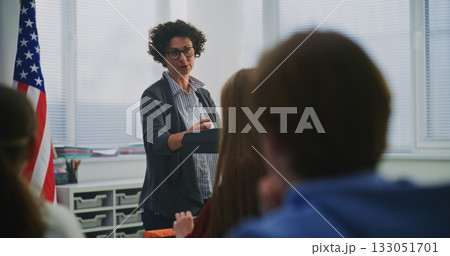 Enthusiastic American Teacher Explains Concept Students During Interactive Classroom Discussion Enthusiastic American Teacher Explains Concept Students During Interactive Classroom Discussion 133051701