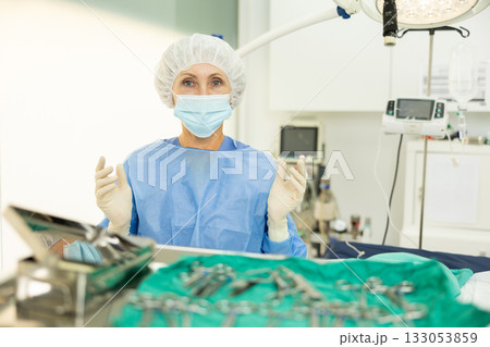 Aged female veterinarian ready to conduct surgical operation at veterinary clinic Aged female veterinarian ready to conduct surgical operation at veterinary clinic 133053859