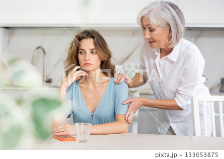 Elderly woman quarreling with adult woman in kitchen 133053875
