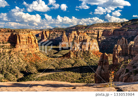 Scenic view of Monument Canyon from Book Cliffs View in Colorado National Monument. Red rock spires, including Independence Monument, fill the canyon under a blue sky 133053984
