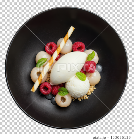 Refreshing gourmet dessert with white lychee sorbet, fresh raspberry, and fruit on dark plate. delicious treat 133056139