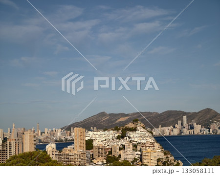 mountain backdrop with city reflections, urban harbor with distant mountain views and bright 133058111