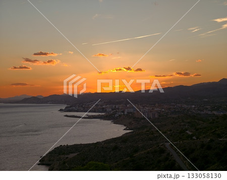 coastal evening with tranquil atmosphere, serene seaside view with glowing sunset and peaceful 133058130