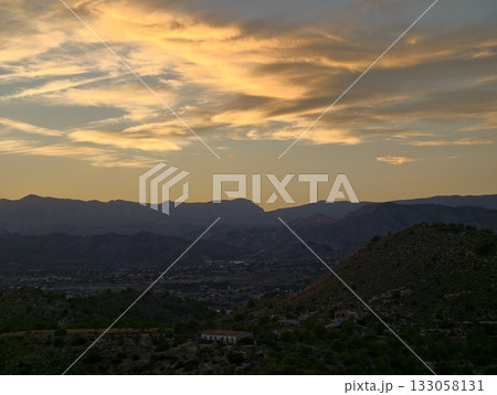 twilight colors paint expansive countryside scenes, sunset hues wash over gentle hills and open 133058131