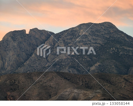 dusk granite landscape, warm sky over rugged terrain, sunset illuminates rocky ridges with peaceful dusk granite landscape, warm sky over rugged terrain, sunset illuminates rocky ridges with peaceful 133058144