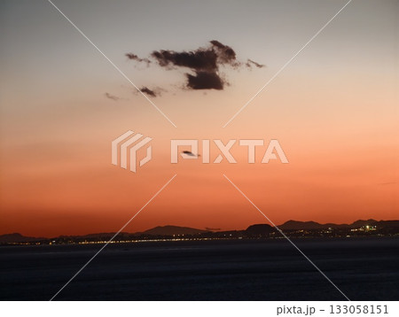 sunset sky with aircraft near harbor, serene aerial view with glowing coast and departing plane sunset sky with aircraft near harbor, serene aerial view with glowing coast and departing plane 133058151