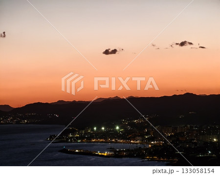 nighttime harbor scene, peaceful night scene of harbor with shimmering reflections and distant city nighttime harbor scene, peaceful night scene of harbor with shimmering reflections and distant city 133058154