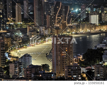 night city beachfront, coastal cityscape glowing against dark night sky with bustling promenade night city beachfront, coastal cityscape glowing against dark night sky with bustling promenade 133058161