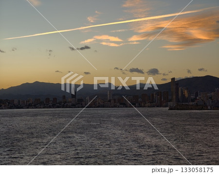 dusk skyline with clouds, peaceful sunset scene featuring distant ridgelines and gentle seascape dusk skyline with clouds, peaceful sunset scene featuring distant ridgelines and gentle seascape 133058175