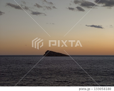 gentle evening sky over calm waters, dreamlike pink haze floats over serene sea during sunset hours gentle evening sky over calm waters, dreamlike pink haze floats over serene sea during sunset hours 133058180