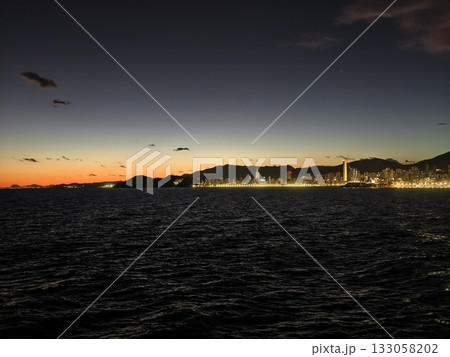 sunset seabirds silhouette scene, scenic sunset capturing seabirds against fiery sky over dark ocean 133058202