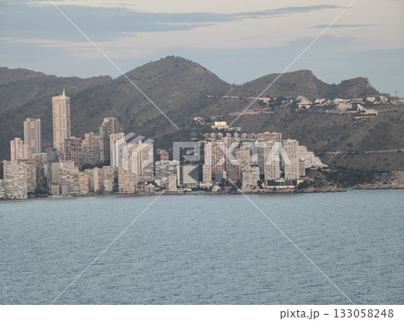 developer reviewing land plots near shoreline, bright toned commercial development with mountain developer reviewing land plots near shoreline, bright toned commercial development with mountain 133058248