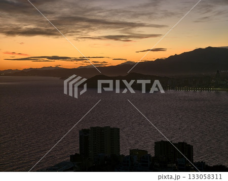 evening waterfront planning, sunset silhouettes of urban coastlines with lighting strategies 133058311