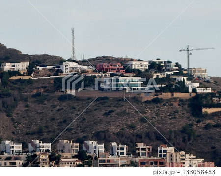 developing hillside villa communities, evolving residential area with cranes and scaffolding 133058483