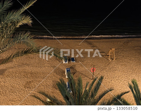 calm nighttime seashore with safety features, serene moonlit coast with patrol and tranquil waves calm nighttime seashore with safety features, serene moonlit coast with patrol and tranquil waves 133058510