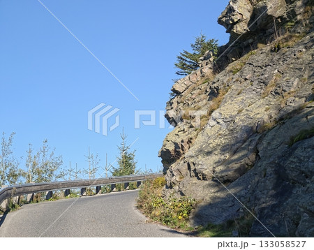 scenic mountain drive, adventure awaits on scenic mountain byway with guardrails and bright blue scenic mountain drive, adventure awaits on scenic mountain byway with guardrails and bright blue 133058527