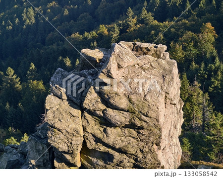 cliff overlooking valley, sunlit granite with pine slopes, rugged terrain with moss and shadows cliff overlooking valley, sunlit granite with pine slopes, rugged terrain with moss and shadows 133058542
