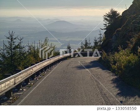 cliffside road with panoramic views, sunlit route winding along high cliffside with vibrant scenery cliffside road with panoramic views, sunlit route winding along high cliffside with vibrant scenery 133058550