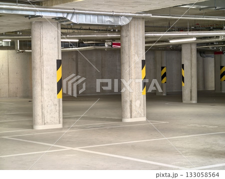 dimly lit concrete parking area, factorystyle parking environment with reflective surfaces dimly lit concrete parking area, factorystyle parking environment with reflective surfaces 133058564