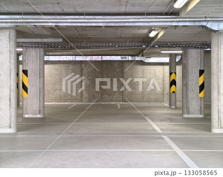 concrete parking space, spacious concrete parking bay with lighting and structural supports concrete parking space, spacious concrete parking bay with lighting and structural supports 133058565