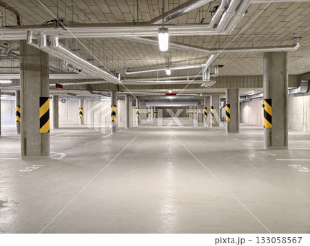 open cement lot with pipes, wide parking facility with visible ductwork and safety markings 133058567