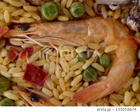 seafood and rice, intimate perspective showcasing fresh shrimp and aromatic seasoned saffron rice 133058674
