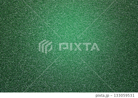 Green glitter textured paper showing gleaming particles, suitable for festive, celebration, or luxurious concepts 133059531