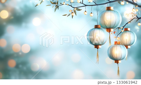 Softly Glowing Lanterns Hanging from a Branch Under a Dreamy Blue Background 133061942