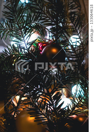 Christmas tree lights, vertical. Christmas tree with bulb garland, close up. Evergreen tree with Christmas decoration. New Year mood. Festive illumination and spruce tree with needles. Merry Christmas 133064618