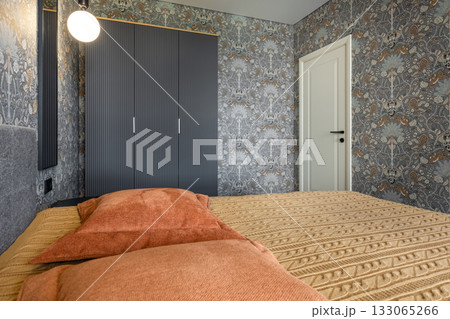 Modern Bedroom with Patterned Wallpaper and Warm Textiles 133065266