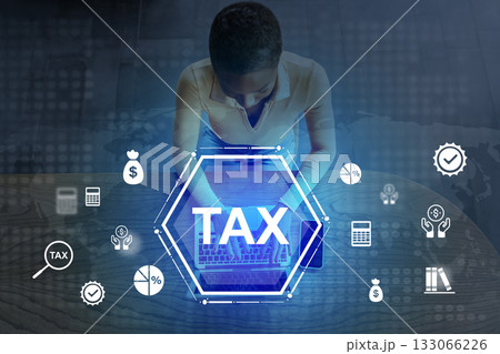 Tax preparation process with modern tools at home desk during daytime Tax preparation process with modern tools at home desk during daytime 133066226