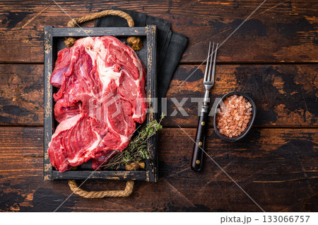 Tender raw beef neck meat, a versatile ingredient for delicious soups and comforting family dinners. wooden background. top view Tender raw beef neck meat, a versatile ingredient for delicious soups and comforting family dinners. wooden background. top view 133066757