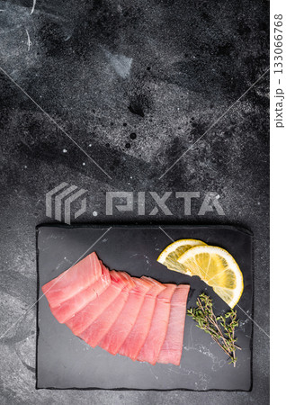 Premium quality tuna sashimi, ideal for a refreshing appetizer or light meal that delights the senses. black background. top view 133066768