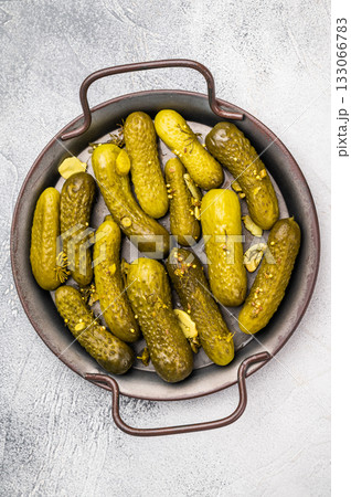 Freshly jarred dill pickles, a delightful addition to any meal or charcuterie board that adds a zesty crunch. grey background. top view Freshly jarred dill pickles, a delightful addition to any meal or charcuterie board that adds a zesty crunch. grey background. top view 133066783