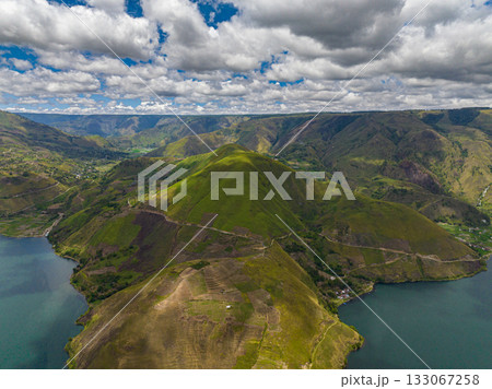 Lake Toba is located in the crater of a volcano and mountains view from above. Sumatra, Indonesia. Lake Toba is located in the crater of a volcano and mountains view from above. Sumatra, Indonesia. 133067258