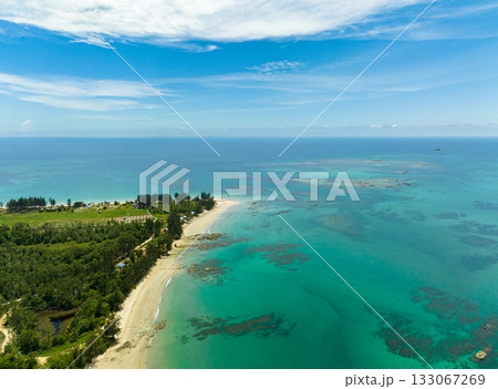 Aerial view of tropical beach with palm trees and a blue ocean. Borneo, Malaysia. Aerial view of tropical beach with palm trees and a blue ocean. Borneo, Malaysia. 133067269