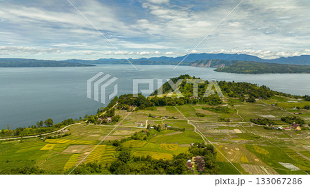 Aerial drone of lake Toba and agricultural land in the countryside in the highlands. Sumatra, Indonesia. Aerial drone of lake Toba and agricultural land in the countryside in the highlands. Sumatra, Indonesia. 133067286