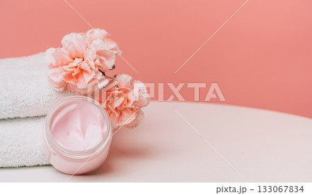 Pink cream jar and carnations with copy space 133067834