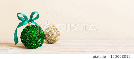 Christmas ball on colored background. decoration bauble with ribbon bow with copy space 133068013