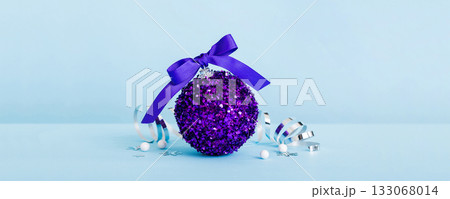 Christmas ball on colored background. decoration bauble with ribbon bow with copy space 133068014