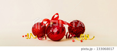 Christmas ball on colored background. decoration bauble with ribbon bow with copy space 133068017