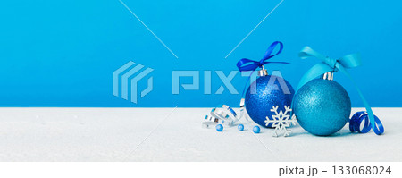 Christmas ball on colored background. decoration bauble with ribbon bow with copy space 133068024